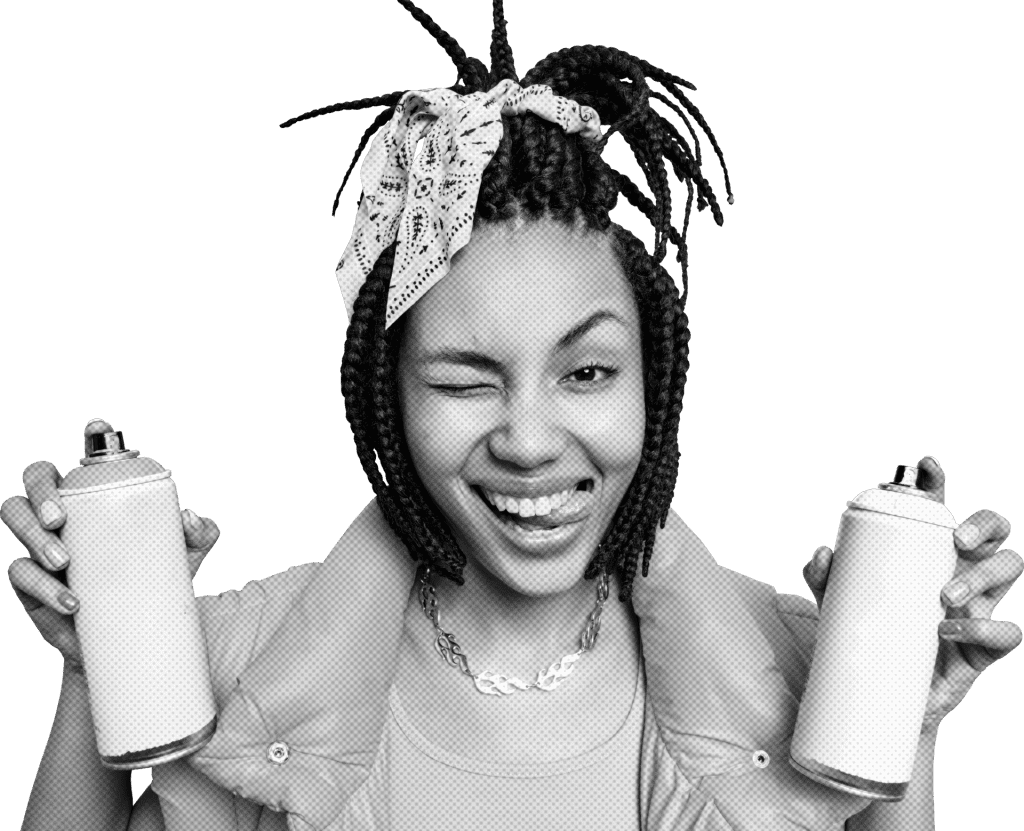 Photograph of a girl holding a spray paint can in each hand and sticking her tongue out.