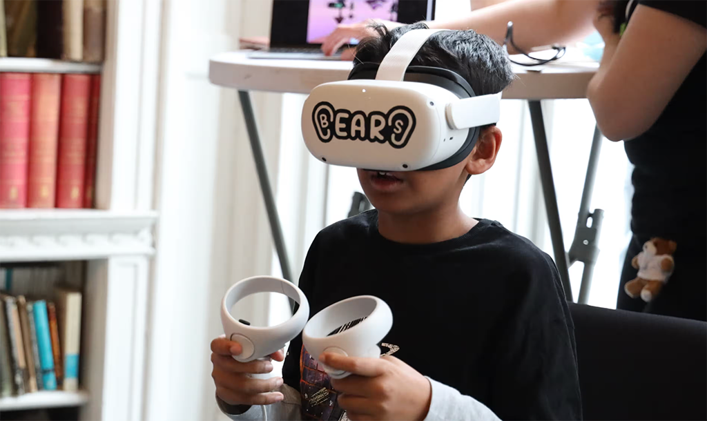 A boy wearing a VR headset, focusing on his game.
