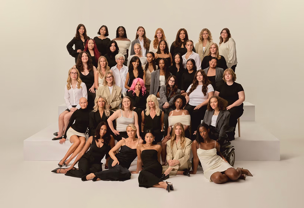 A large group of women, representing different intersectionalities, cultures and backgrounds pose for a camera together on a staged platform. These are the Djerf Avenue Icons.