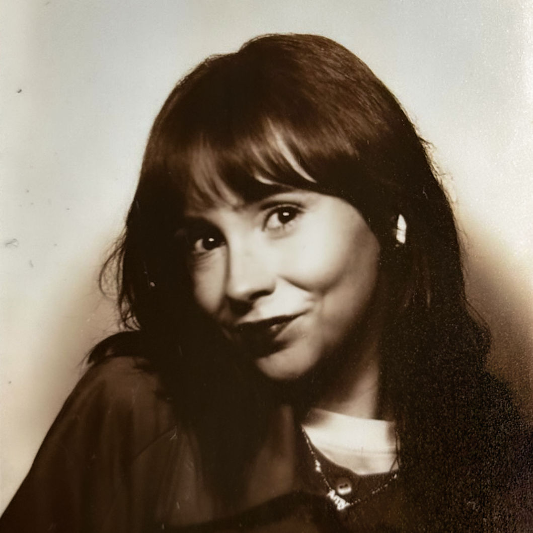 A black and white headshot of Amy, a white female with long hair and curtain bangs.