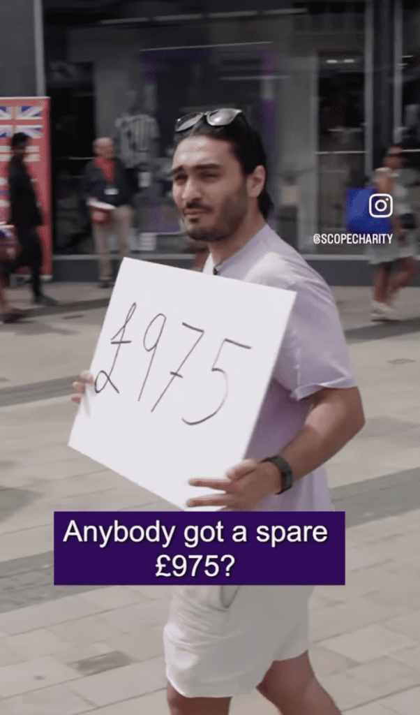 Screenshot of a reel where Moeed Majeed walks around a town centre with a board that says "£975."