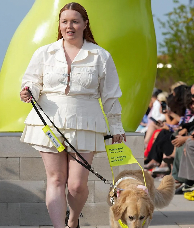 Lucy Edwards walks down the runway with her guide dog at Copenhagen Fashion Show.