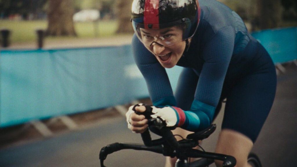 Still from the Channel 4 Paris 2024 Paralympics advert showing a Paralympic cyclist competing on the road.