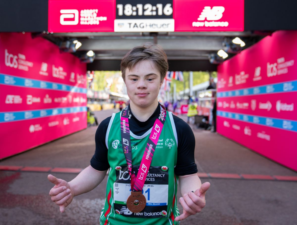 Lloyd poses for a photo with his medal for completing the London Marathon.