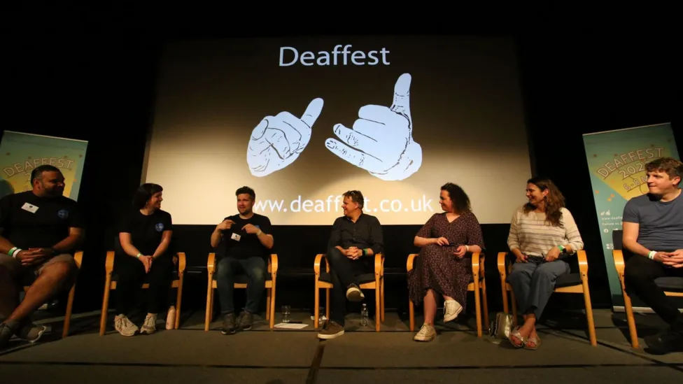 A group panel of people discussing a topic at Deaffest.