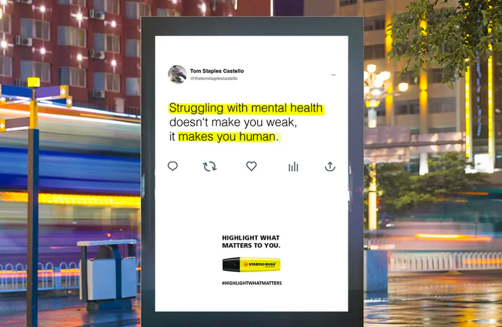 A tweet about mental health on a campaign board in a public setting. The important information is highlighted, which is supported by text underneath that reads: "Highlight what matters to you," with a picture of a Stabilo highlighter.